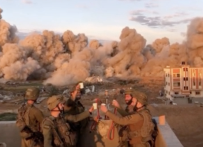 Soldater sk&aring;ler og feirer mens bomber g&aring;r av i bakgrunnen